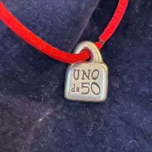 UNO de 50 small charm. On red cord